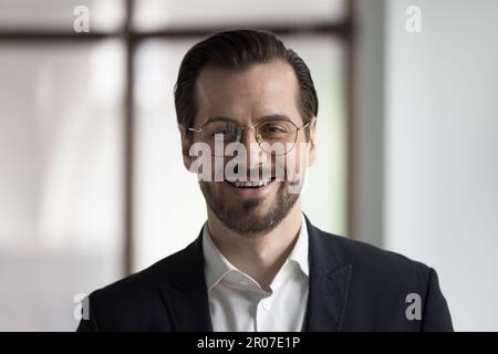 Positive young business leader posing look at camera Stock Photo