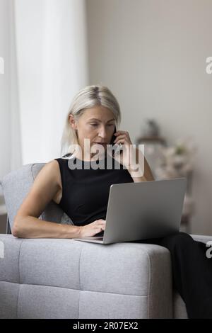Confident mature older business woman working from home Stock Photo