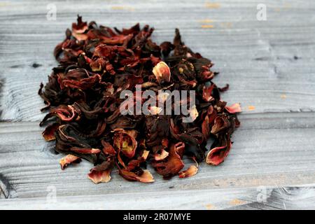 Dried Roselle herbs isolated, a dark red-purple colored bissap wonjo natural herbs, flowers of the Roselle plant Hibiscus used to prepare Roselle Juic Stock Photo