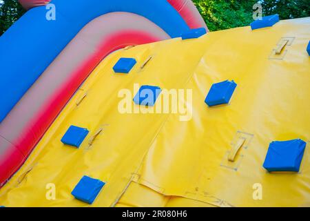 Detail of a brightly colored bouncy castle, empty without children. Stock Photo