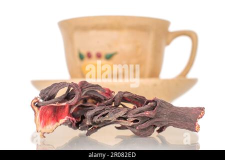 Fragrant karkade tea with ceramic cup, macro, isolated on white background. Stock Photo