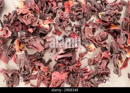 Dry aromatic karkade tea on a metal tray, macro, top view. Stock Photo
