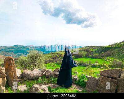 The Clergyman stands next to the Armenian monastery Stock Photo