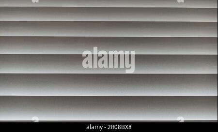 Window blinds with wavy gray striped background Stock Photo