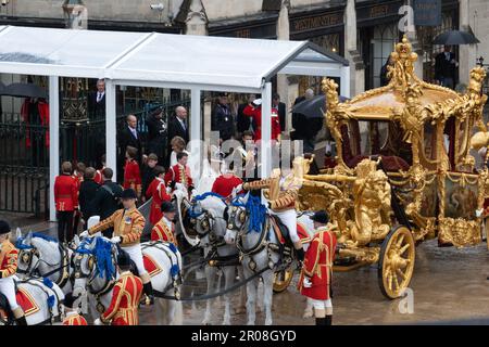 King Charles III, wearing The Imperial State Crown,  leaves Westminster Abbey after being crowned, at the coronation.  He is about to return to Buckingham Palace on board the Gold State Coach, which has been used to transport very British Monarch since it was built in 1762.  It was designed by William Chambers and made by the coach maker Samuel Butler Stock Photo