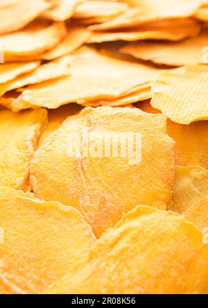 Dried large sweet mango slices on white background.Macro Stock Photo
