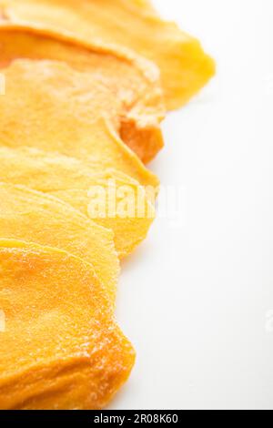 Dried large sweet mango slices on white background.Macro Stock Photo