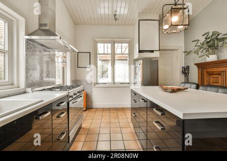 Kitchen with white stone countertops, solid wood cabinets, and vintage tile  on the walls Stock Photo - Alamy