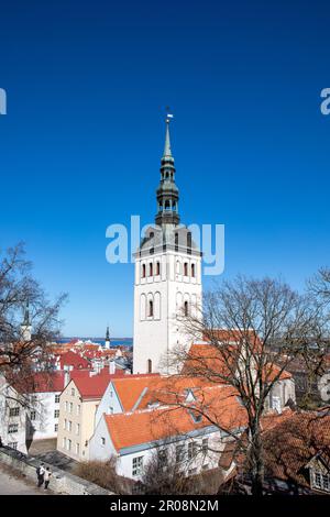 St. Nicholas Church or Niguliste Kirk belfry above old town or Vanalinn rooftops on a sunny spring day in Tallinn, Estonia Stock Photo