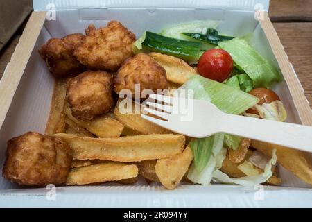 Children chicken nuggets meals in a box with wooden fork Stock Photo