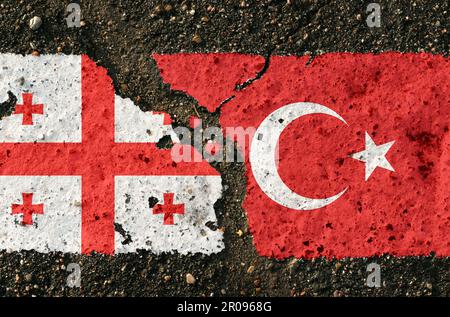 On the pavement there are images of the flags of Georgia and Turkey, as a symbol of confrontation. Conceptual image. Stock Photo