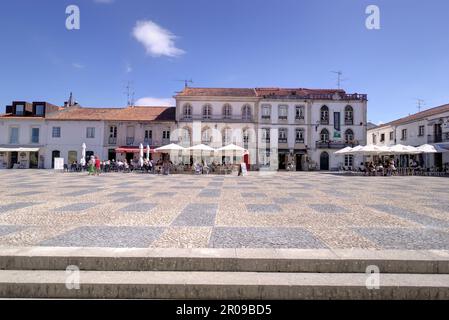 Batalha, Portugal - August 15, 2022: Town square with restaurants, shops and numerous tourists some motion blurred and some eating and drinking outsid Stock Photo