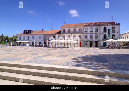 Batalha, Portugal - August 15, 2022: Town square with restaurants, shops and numerous tourists some motion blurred and some eating and drinking outsid Stock Photo