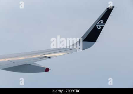 Wellington, New Zealand - April 20, 2023: A close up view of an Air New Zealand wing with it's iconic flying through the sky on a trip from Wellington Stock Photo