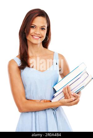 Shes a diligent student. Smiling young woman holding a pile of textbooks against a white background. Stock Photo