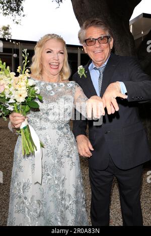 May 6, 2023, Ojai, California, USA: EXCLUSIVE! Newlyweds Former Happy Days star 'Potsie' aka ANSON WILLIAMS, 73, and SHARON MAHARRY, 64 show off rings. The actor, who filed for divorce from his wife of 30 years in 2019, wore a black suit with a light blue shirt and a gray patterned tie. He had a boutonniere on the lapel of his jacket and wore black eyeglasses. The bride, who is a real estate agent in Ojai, California, wore a gorgeous, long-sleeved floor length white lace gown with a boat neck and full skirt. She wore her blonde hair pinned back off her face and carried a pretty bouquet of rose Stock Photo