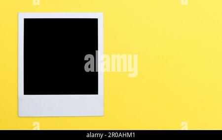 Polaroid photo frame on yellow background Stock Photo