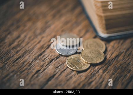 One tenth or tithe is basis on which Bible teaches us to give one tenth of first fruit to God. coins with Holy Bible. Biblical concept of Christian of Stock Photo