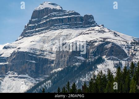 Beautiful mountain views in Banff National Park during spring time with magnificent mountain peak and blue sky in background. Stock Photo