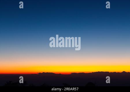Sky gradient from blue to orange sunset Stock Photo