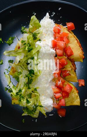 Mashed Potato and Chorizo Tacos Dorados with Toppings Stock Photo