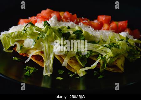 Mashed Potato and Chorizo Tacos Dorados with Toppings Stock Photo