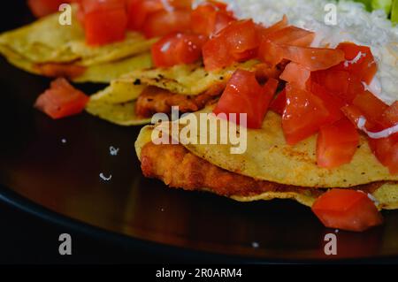 Mashed Potato and Chorizo Tacos Dorados with Toppings Stock Photo