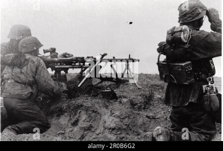 World War Two B&W photo German Soldiers in Camo Smocks fire an MG on the Russian Front 1941 . The Soldiers are members of the 2nd SS Division Das Reich SS KB fendt. Stock Photo