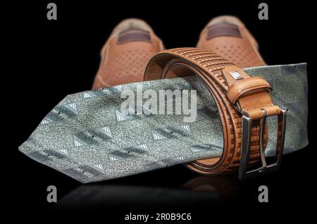neck tie, strap and shoes  isolated on a black background Stock Photo