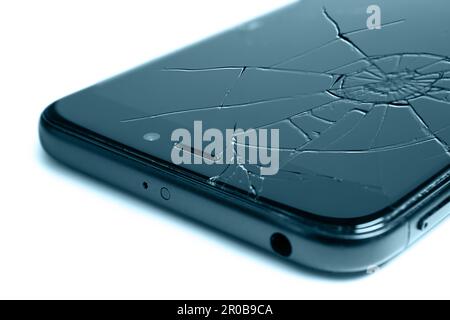 Close-up of a smartphone with a broken display, isolated on a white background Stock Photo