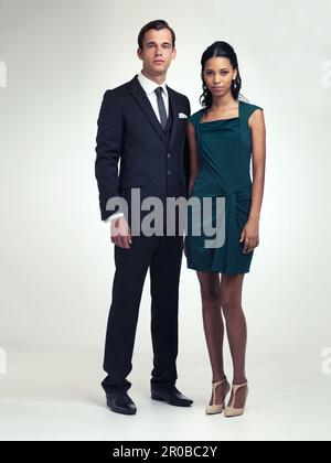 Theyre the picture of class and sophistication. A full length portrait of an attractive young man and woman wearing vintage evening wear. Stock Photo