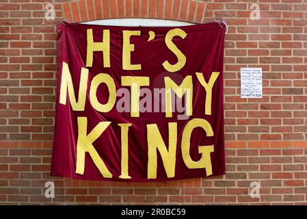 Opposition to King Charles coronation. He's not my king banner on the side of a house with a hand written note why.  May 2023 Stock Photo