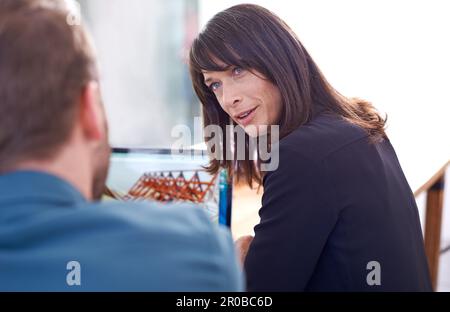 Giving out advice. two architects having a discussion in their office. Stock Photo