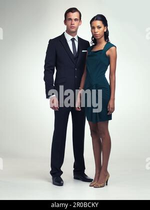 Classic good looks. A full length portrait of an attractive young man and woman wearing vintage evening wear. Stock Photo