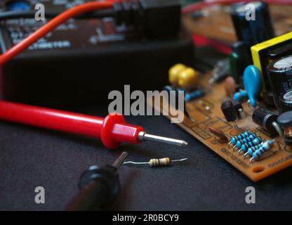 Electronic components on the board.  Removed and on board resistors. Repairing electrical device. Focused on resistors. Stock Photo