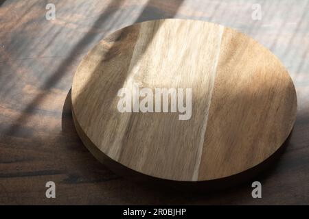 photo round wooden board side view from above on a dark background Stock Photo