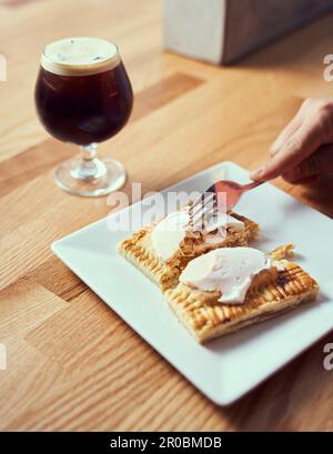 A pop tart pastry being cut and served with nitro cold brew. Stock Photo