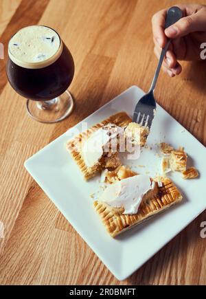 A pop tart pastry being cut and served with nitro cold brew. Stock Photo