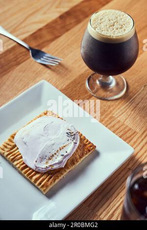 A nitro cold brew served with breakfast pastry. Stock Photo
