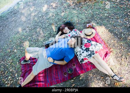 Young couple relaxing on picnic blanket Stock Photo