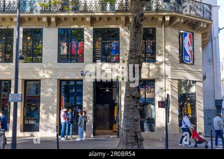 Paris, France - October 27, 2022: The Exterior of an NBA store with pedestrians passing by outside the store. Stock Photo