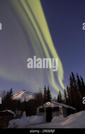 Northen Lights in Wiseman, Alaska over a small cabin Stock Photo