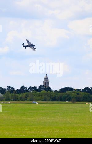 Avro Lancaster PA474 of the Royal Air Force, RAF, Battle of Britain Memorial Flight at low level over RAF College Tower, Cranwell, 7 May 2023. Stock Photo