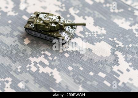 The toy tank is on the table. Children's toy military tank Stock Photo