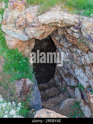 mysterious entrance to an underground dungeon in a prehistoric tower in Sardinia, Italy. Stock Photo