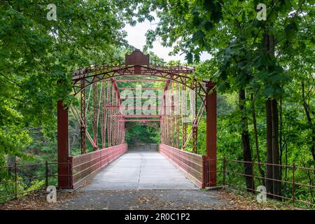 New Milford, CT, USA-August 2022; View over the wrought-iron Lover's Leap Bridge, a  lenticular truss bridge over the Housatonic River located in Love Stock Photo