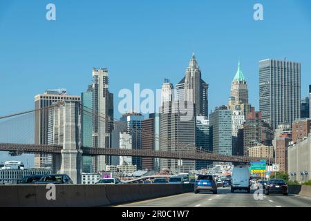 New York City, NY, USA-October 2022; Drivers view in southerly direction over a busy FDR Drive at Lower East Side with Brooklyn Bridge and Financial D Stock Photo