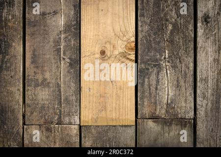 New plank of wood on a boardwalk of old planks Stock Photo