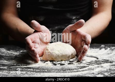 Baker's hands knead the dough prepares a delicious tortilla. Stock Photo