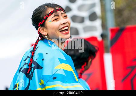 Close up of young adult women Japanese Yosakoi dancer with red and black cord headband. Close up, face. She is laughing and looks very happy. Stock Photo
